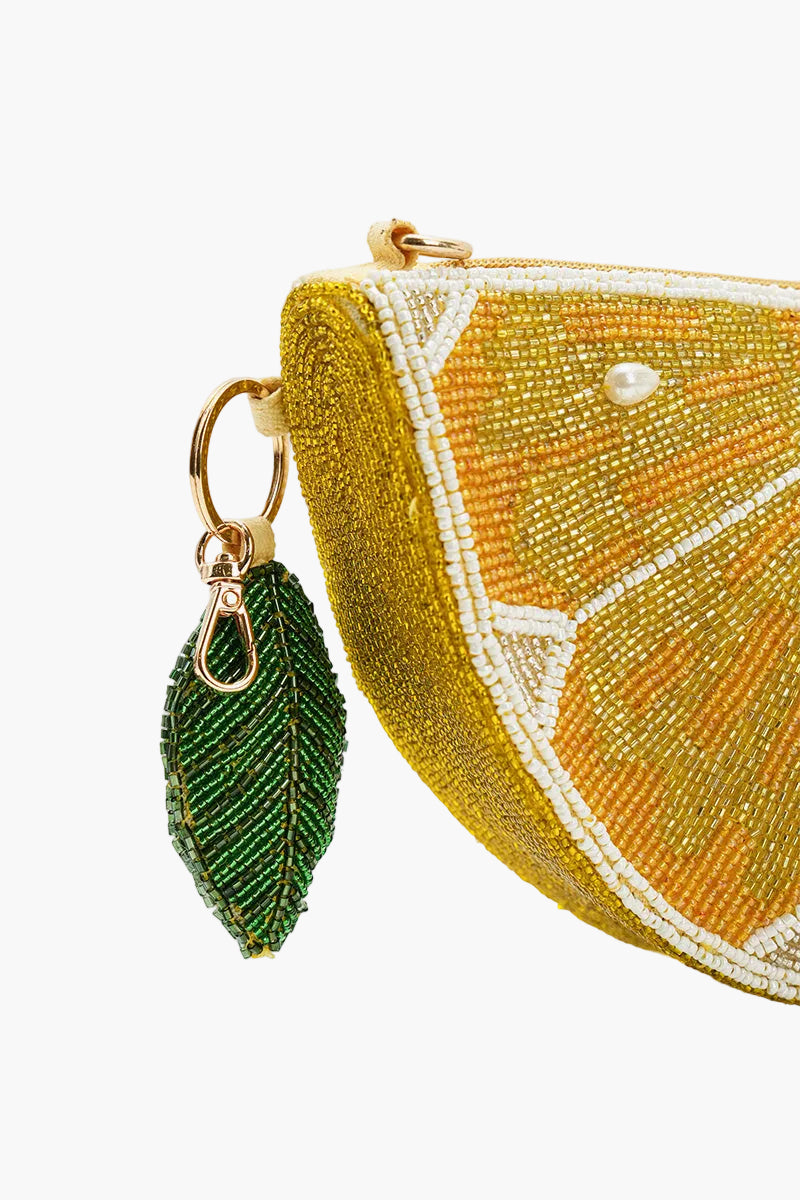 Beaded citrus fruit-shaped pouch with a green leaf keychain on a white background
