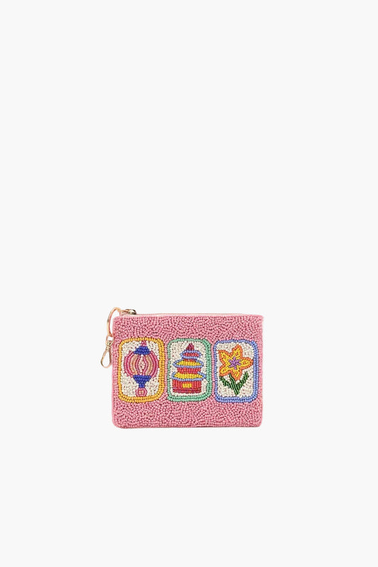 Pink pouch with colorful embroidered designs on a white background
