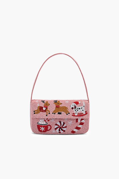 Christmas-themed handbag with reindeer, Santa, and candy cane design on a white background