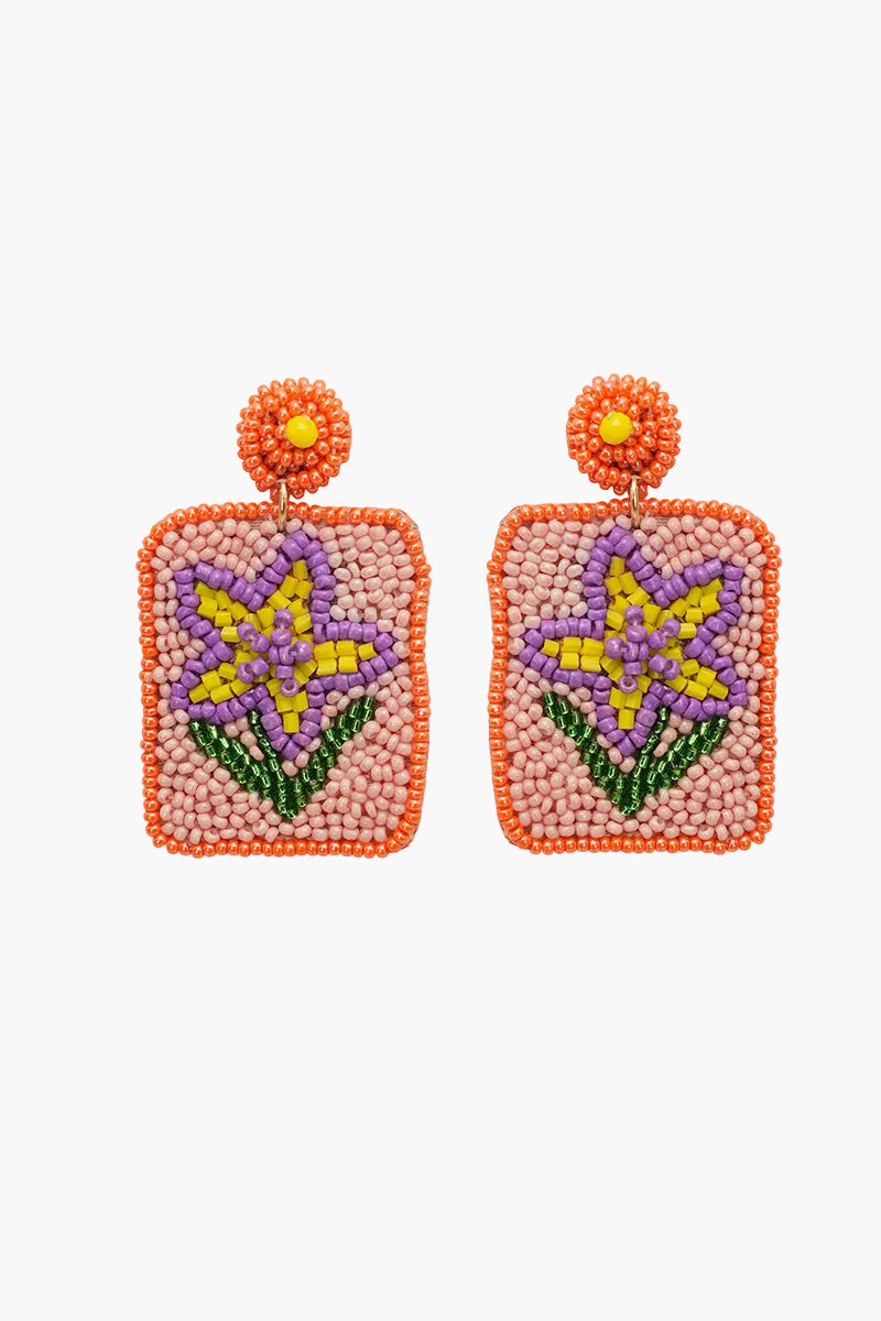 Pair of beaded earrings with star design on a white background