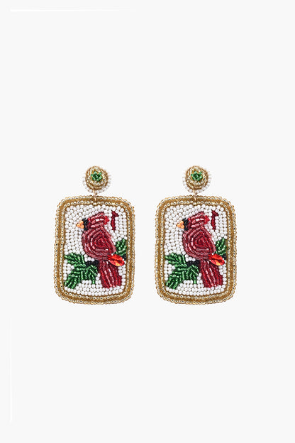 Pair of earrings with cardinal design on a white background