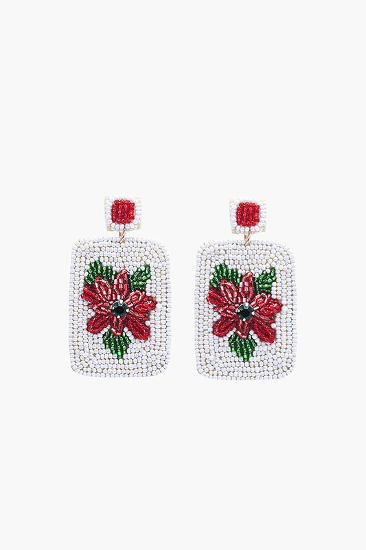Square beaded earrings with red floral design on a white background
